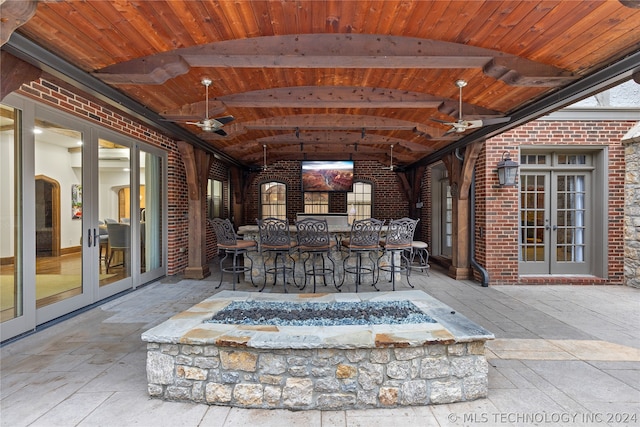 view of patio featuring exterior bar, ceiling fan, and french doors