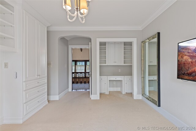 interior space featuring crown molding, light carpet, and a chandelier