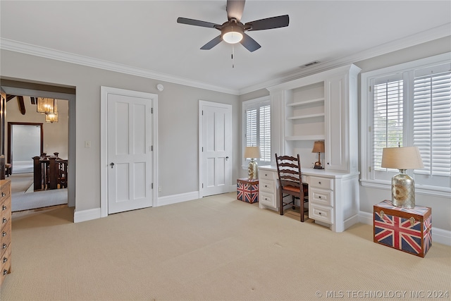 carpeted office space with built in features, ceiling fan with notable chandelier, and crown molding