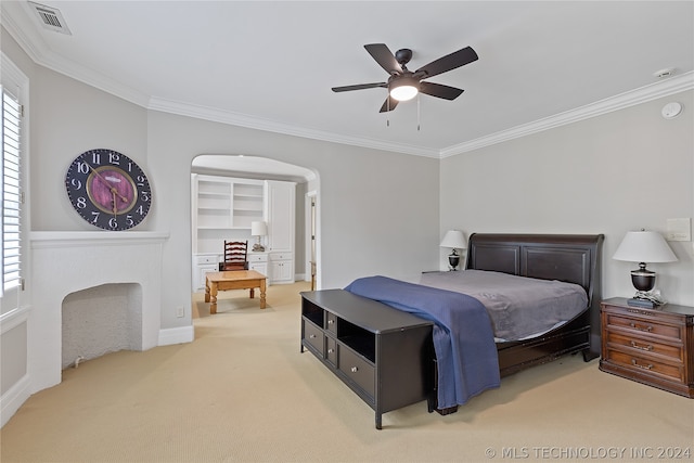 bedroom with a spacious closet, ornamental molding, ceiling fan, and carpet floors