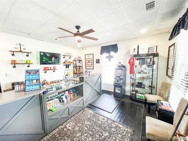 kitchen with dark wood-type flooring, a paneled ceiling, and ceiling fan