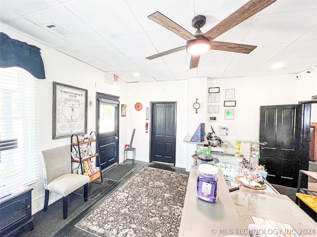 office area featuring a paneled ceiling and ceiling fan