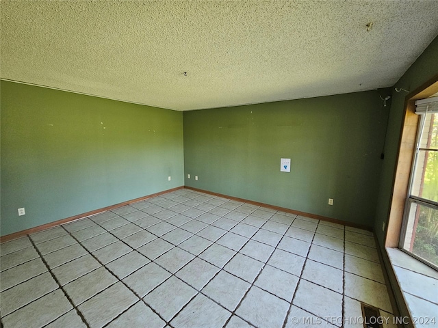 unfurnished room featuring a textured ceiling