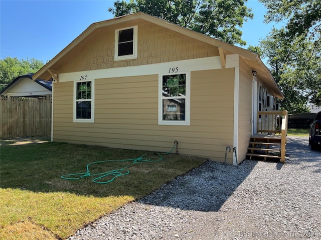 view of side of property with a lawn