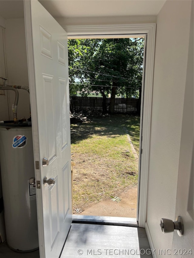 doorway featuring gas water heater and concrete floors