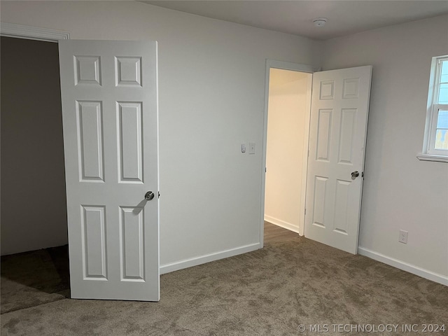 unfurnished bedroom featuring carpet