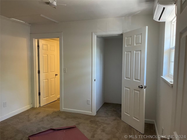 unfurnished bedroom featuring light colored carpet and an AC wall unit