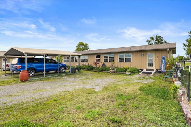 single story home featuring a carport and a front yard