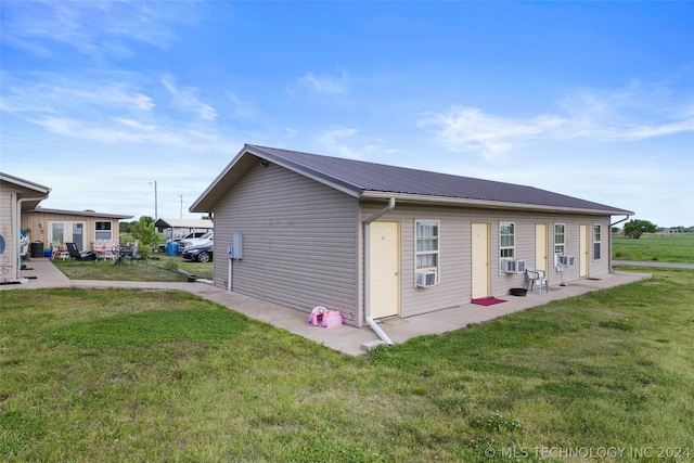 view of side of property featuring a yard and cooling unit