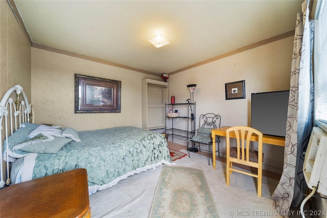 bedroom with crown molding and carpet floors