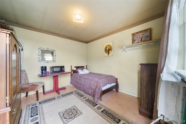 bedroom featuring crown molding