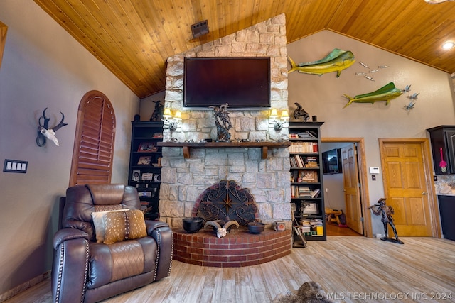 living room with wooden ceiling, hardwood / wood-style flooring, a fireplace, and vaulted ceiling