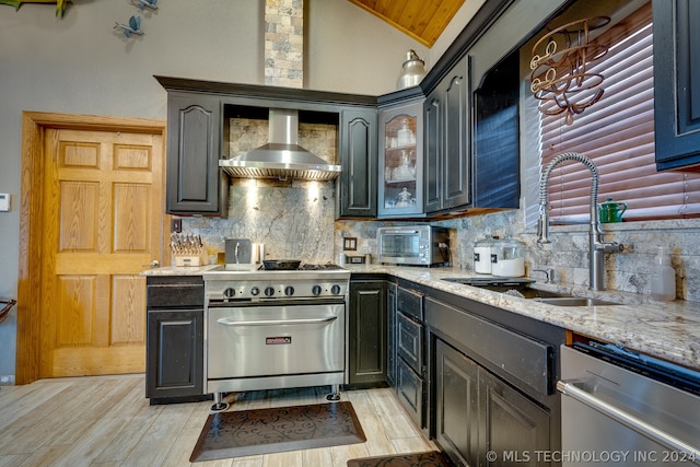 kitchen featuring light hardwood / wood-style floors, tasteful backsplash, stainless steel dishwasher, range, and wall chimney range hood