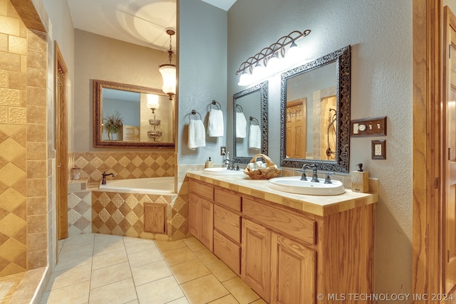 bathroom with dual vanity, separate shower and tub, and tile floors