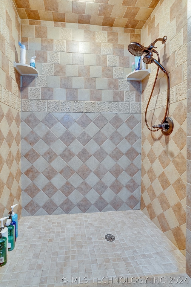 bathroom with tiled shower