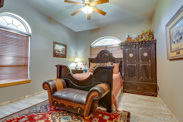 bedroom featuring ceiling fan, hardwood / wood-style floors, and lofted ceiling