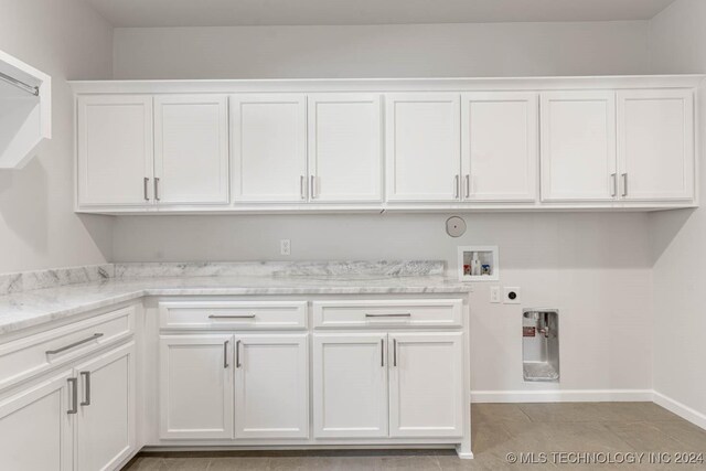 laundry room with electric dryer hookup, cabinets, hookup for a gas dryer, washer hookup, and light tile patterned flooring