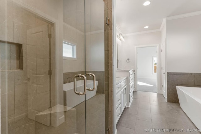 bathroom with tile patterned floors, crown molding, vanity, independent shower and bath, and tile walls