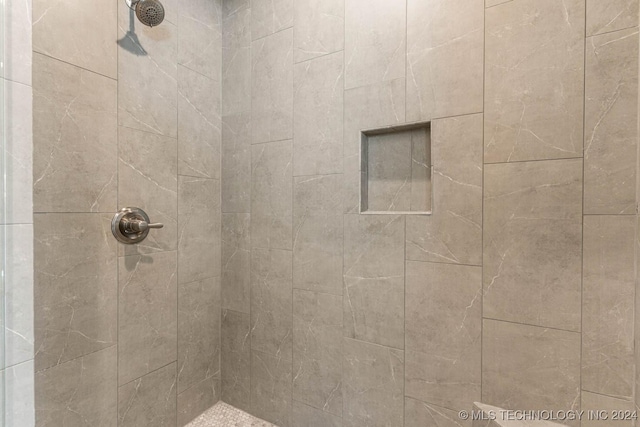 bathroom with tiled shower