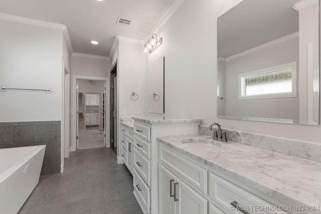 bathroom with tile patterned floors, vanity, a bath, and ornamental molding