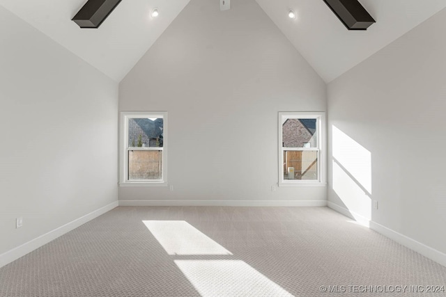 bonus room featuring high vaulted ceiling and light colored carpet