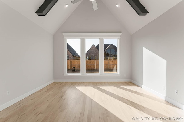 bonus room with light hardwood / wood-style floors, high vaulted ceiling, and ceiling fan