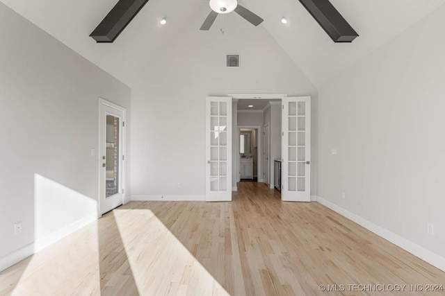 spare room with french doors, light hardwood / wood-style floors, high vaulted ceiling, and ceiling fan