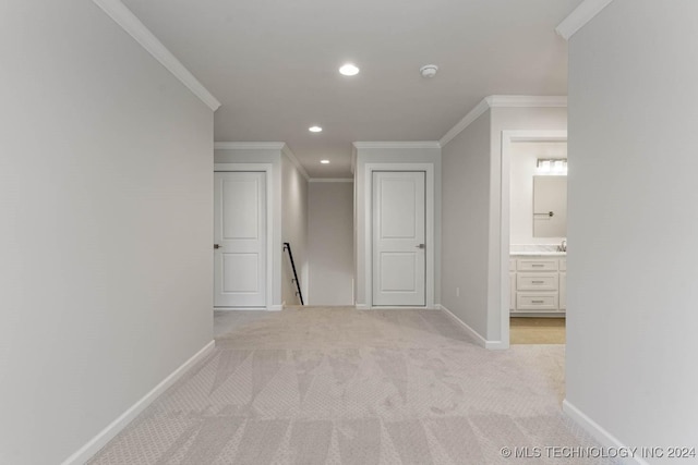 hallway featuring light carpet and ornamental molding