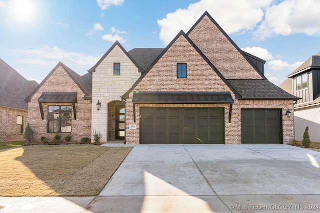 view of front of property with a front lawn and a garage