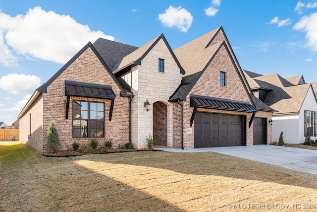 view of front of property with a garage and a front lawn