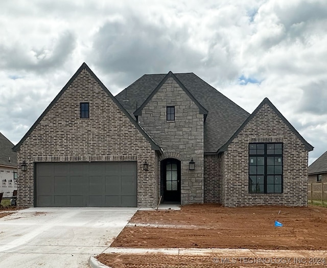 french country style house with a garage