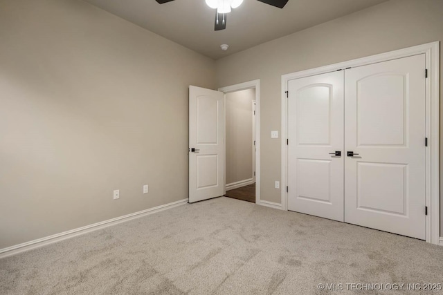 unfurnished bedroom with light carpet, a closet, and ceiling fan