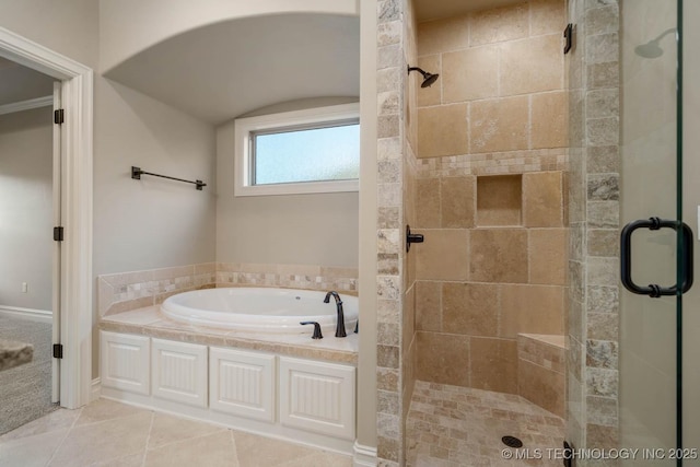 bathroom with tile patterned flooring, ornamental molding, and plus walk in shower