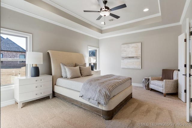 bedroom with baseboards, a raised ceiling, crown molding, and light colored carpet