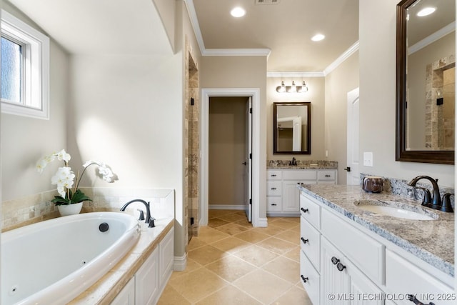 full bath featuring crown molding, two vanities, a sink, and a garden tub