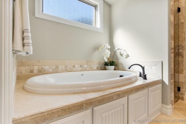 full bath with tile patterned flooring, a garden tub, and a shower stall