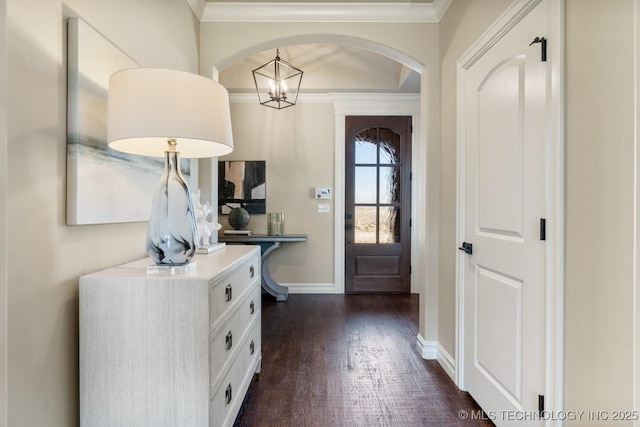 entrance foyer featuring ornamental molding, baseboards, and dark wood-style floors