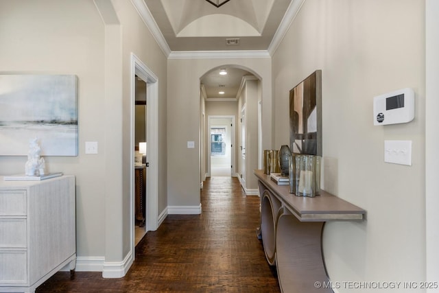 hall featuring arched walkways, dark wood-style flooring, crown molding, and baseboards