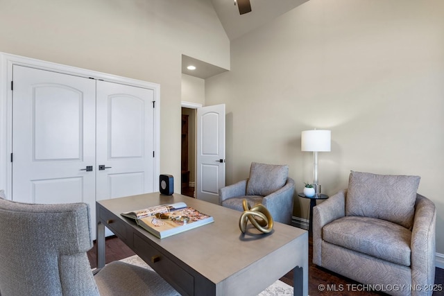 office area with high vaulted ceiling and dark wood-style floors