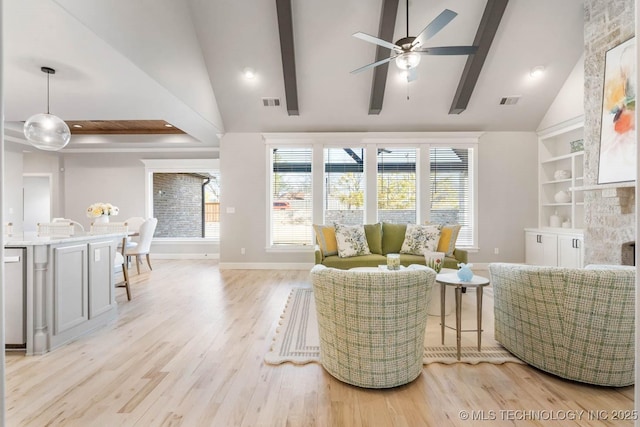 living room featuring baseboards, visible vents, beamed ceiling, light wood-style floors, and a fireplace