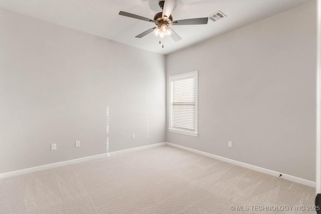 empty room featuring light carpet, a ceiling fan, visible vents, and baseboards