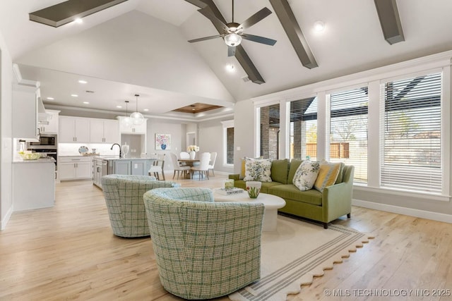 living room with high vaulted ceiling, recessed lighting, a ceiling fan, baseboards, and light wood-style floors