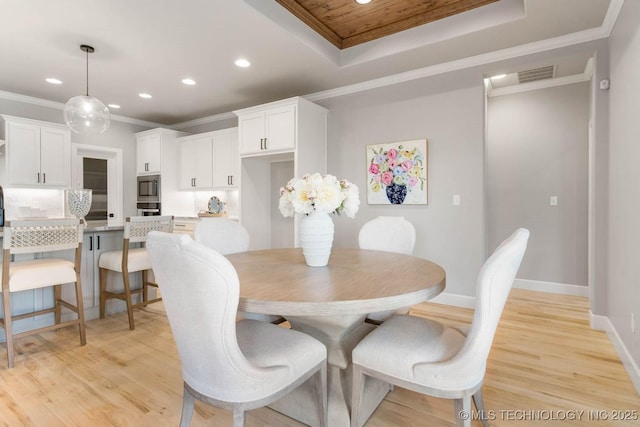 dining room featuring ornamental molding, light wood finished floors, and recessed lighting