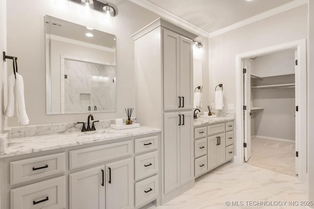 full bathroom with marble finish floor, ornamental molding, a walk in closet, and vanity