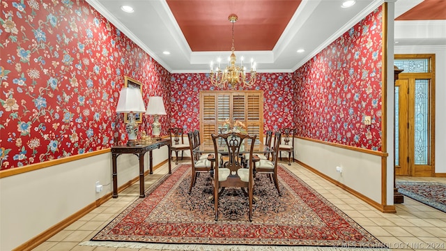 tiled dining room featuring a tray ceiling, crown molding, and an inviting chandelier