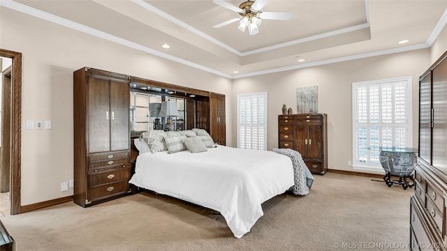 bedroom featuring crown molding, ceiling fan, a raised ceiling, and light colored carpet