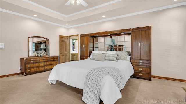 bedroom featuring a raised ceiling, ceiling fan, crown molding, and carpet flooring