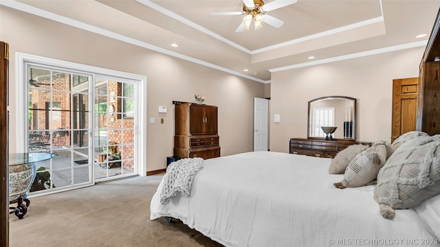 bedroom with access to exterior, a tray ceiling, ceiling fan, ornamental molding, and carpet floors