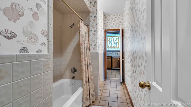 bathroom with tile flooring and shower / tub combo with curtain