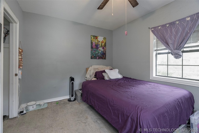 bedroom with ceiling fan and light carpet